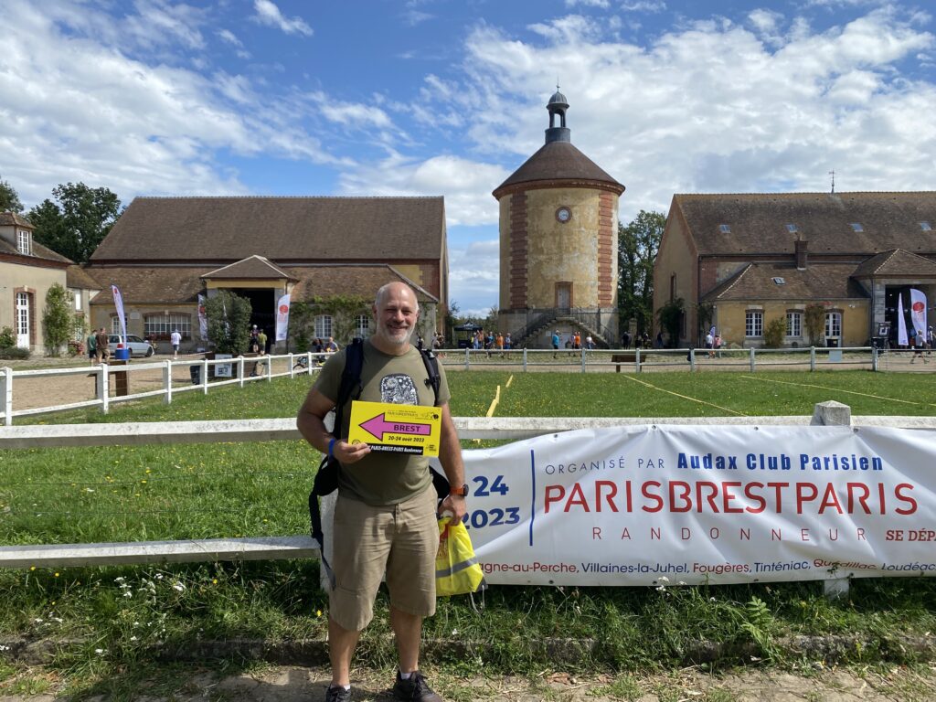 Standing in front of the Paris-Brest-Paris sign at la Bergerie Nationale de Rambouillet